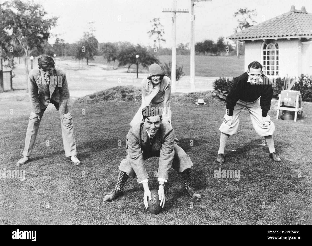 Tampa, Florida  January 7, 1926 Four of America's most famous sports stars give an athletic demonstration at the Temple Terrace Country Club. L-R: JIm Barnes, British Open Golf Champion; Helen Wainwright, Olympic diving and swimming medal winner, 'Red' Grange, football star; and center is Johny Farrell, professional golf champion. Stock Photo