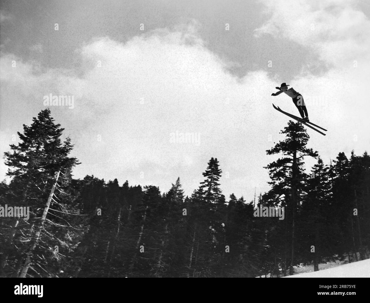 Big Pines, California:  January 27, 1937 Sigurd Ulland of the Lake Tahoe Ski Club, takes the leap off a mountain and takes home the prize in the Invitational International Ski Tournament ofr the second straight year. Stock Photo