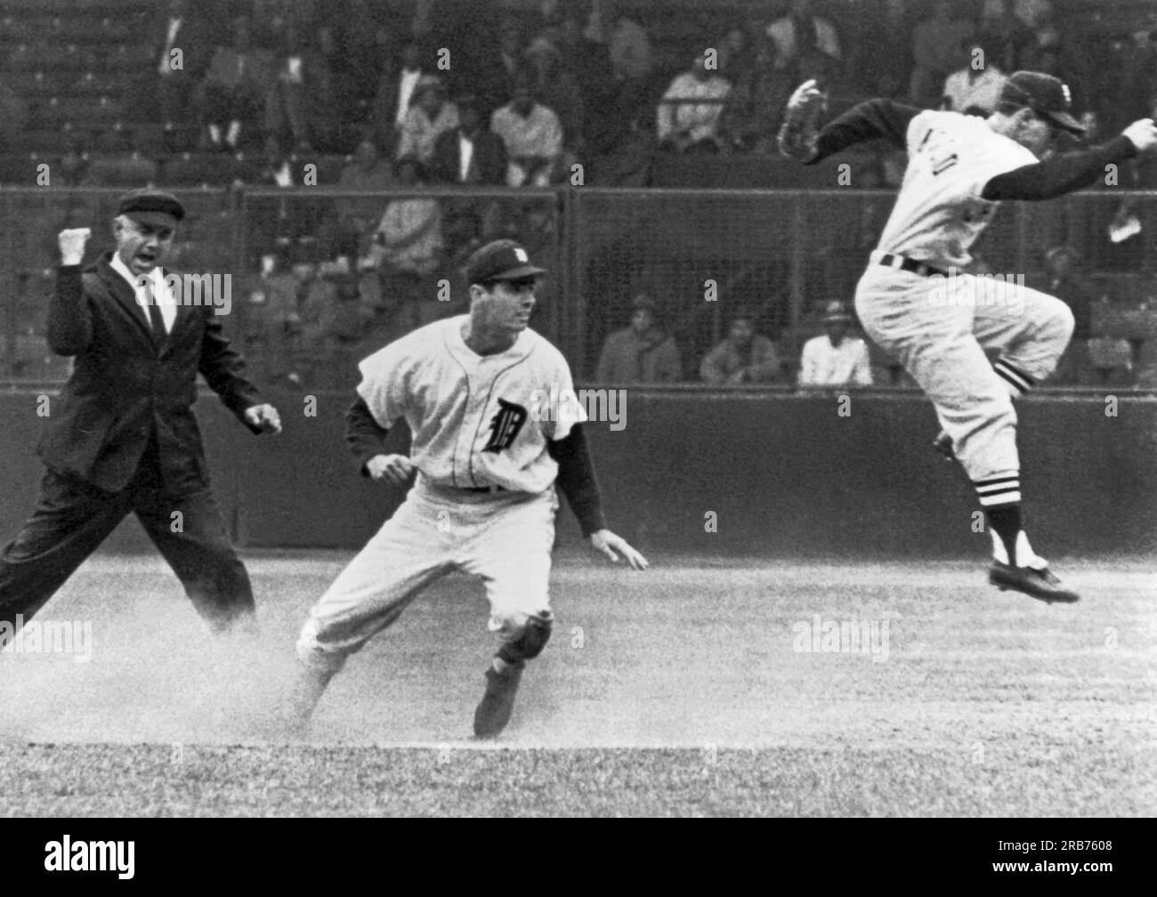 Detroit, Michigan:  c. 1961 Detroit's Rocky Colavito  is called out at second by umpire Sam Carrigan as Chicago White Sox shortstop Luis Aparicio leaps out of the way after stepping on second base. Stock Photo
