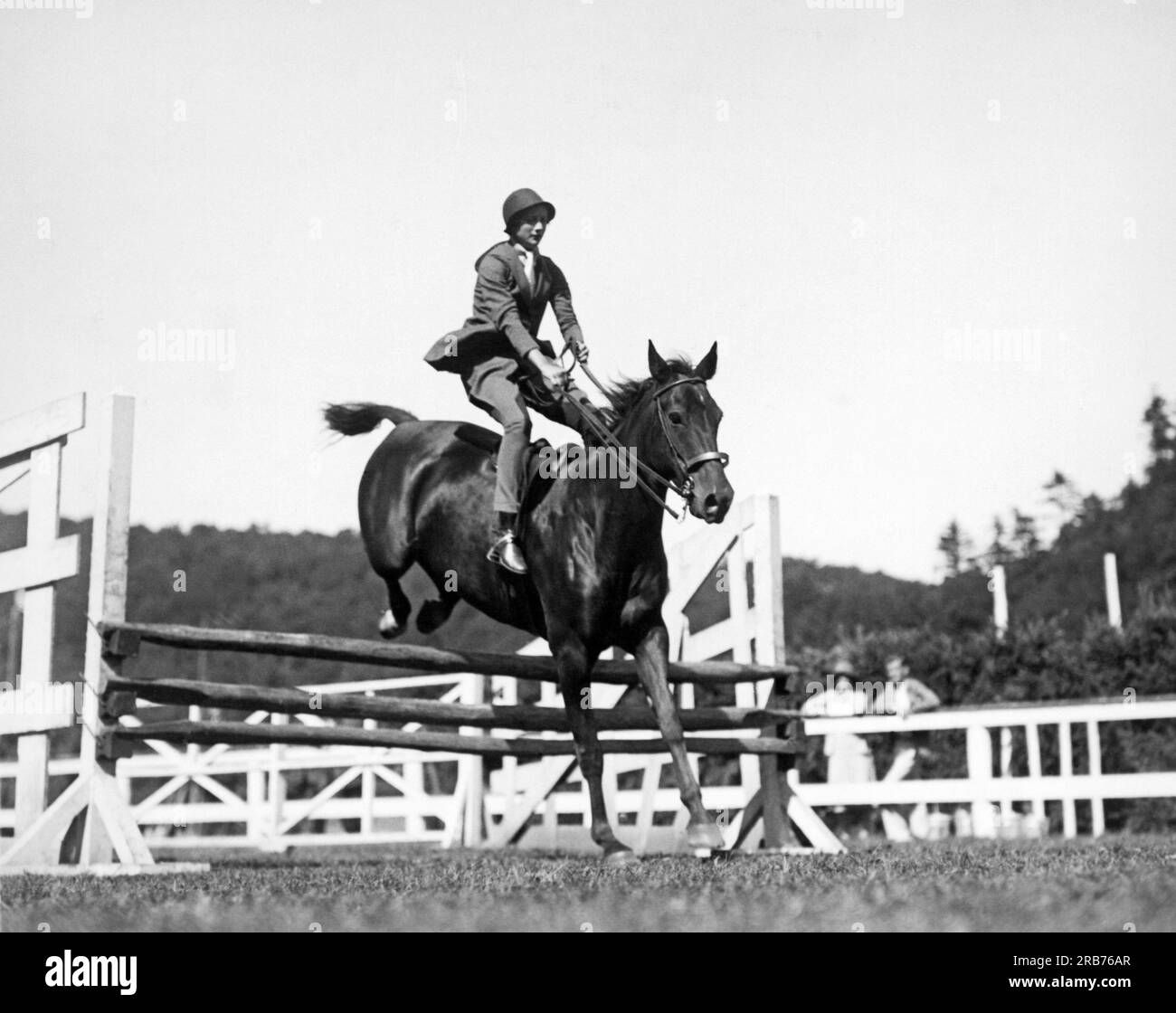 Tuxedo Park, New York:  c. 1929. New York Social Blue Book member Miss Edith Betts going over the jumps in the Tuxedo Junior Horse Show for the benefit of Tuxedo Memorial; Hospital. Stock Photo