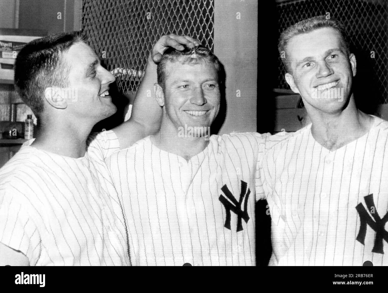 New York, New York:  July 2, 1961. Tony Kubek, Mickey Mantle, and Roger Maris celebrate a victory over the Washington Senators in the Yankee Stadium clubhouse. Maris hit one home run, and Mantle hit two in the game. Stock Photo