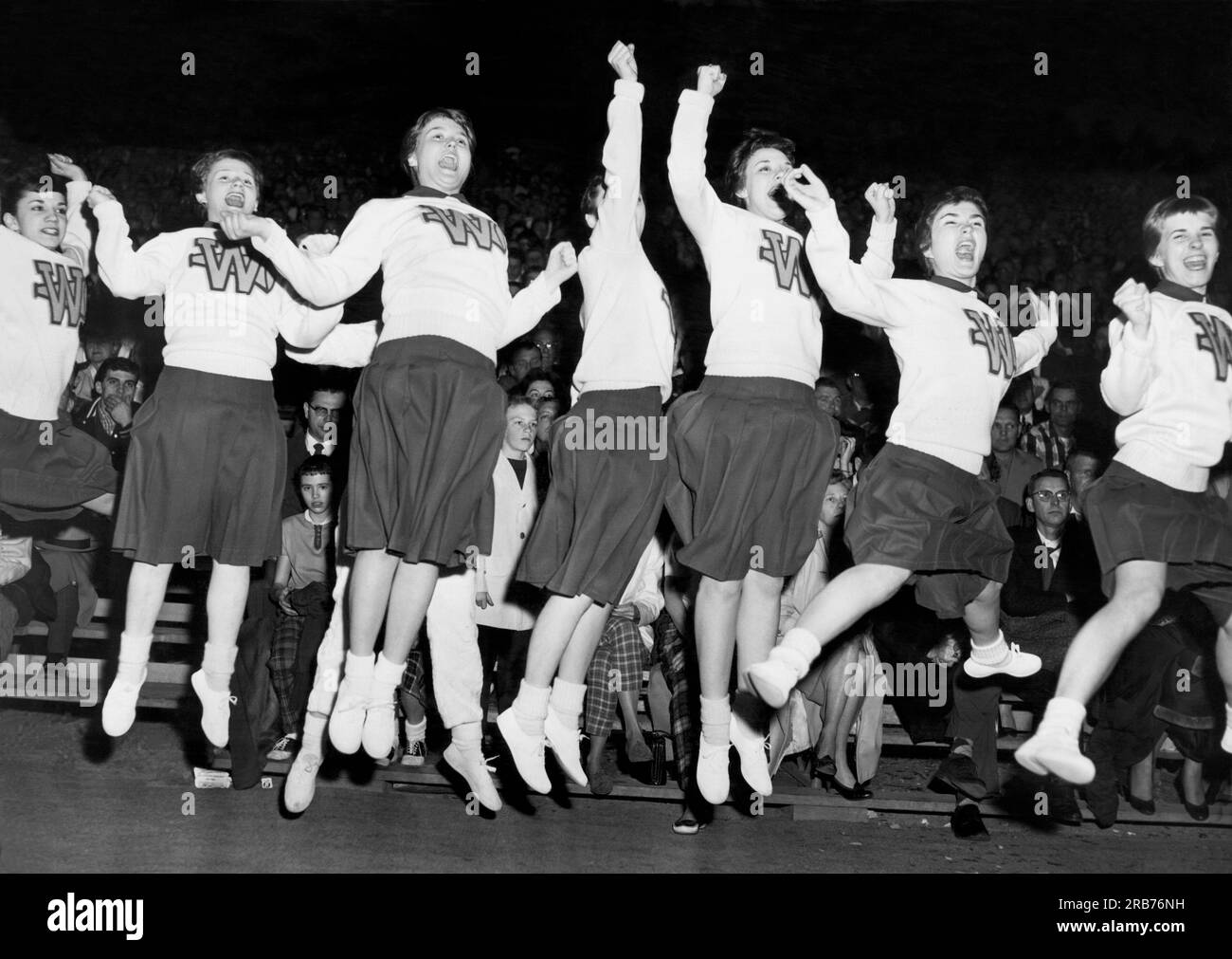 Waukegan, Illinois:  March 18, 1959 Waukegan cheerleaders jump for joy as their team stages a last second win. Stock Photo