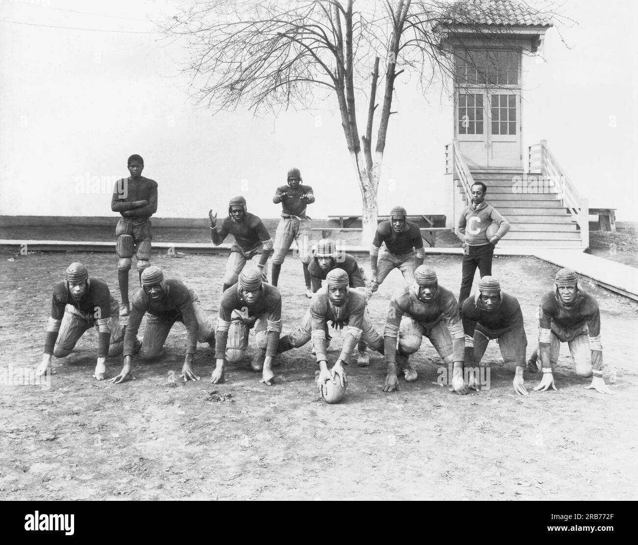 Winchester, Kentucky:  c. 1921 The African American football team at Oliver High School and their coach, E.J. Hooper, lined up for a portrait. Stock Photo