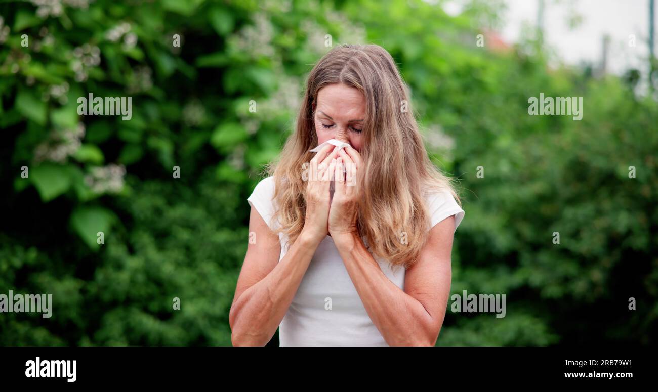 Allergic Nose And Pollen Allergy. Sneezing Into Handkerchief Stock Photo