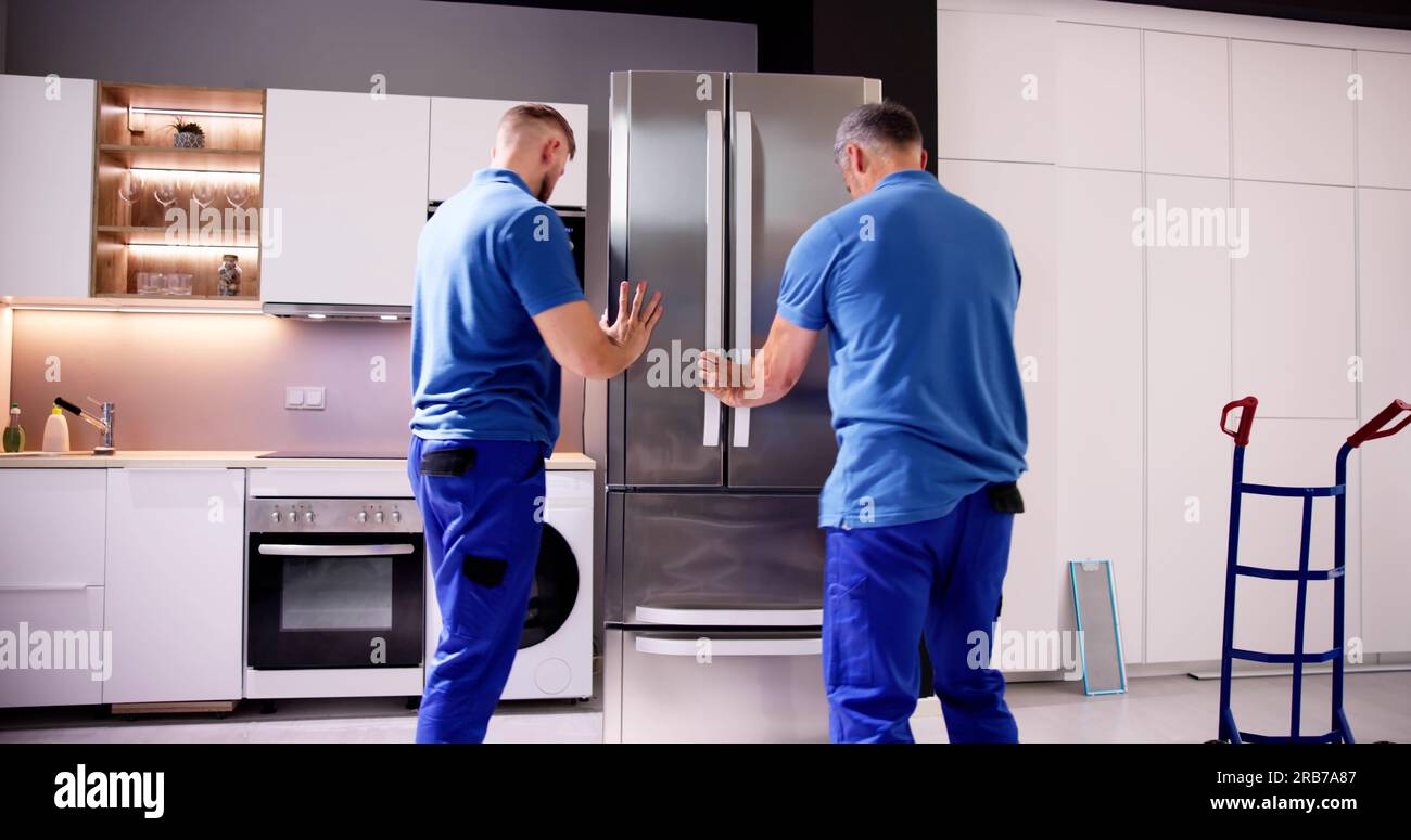 Delivery And Install Of Refrigerator Appliance. Mover Carrying Fridge