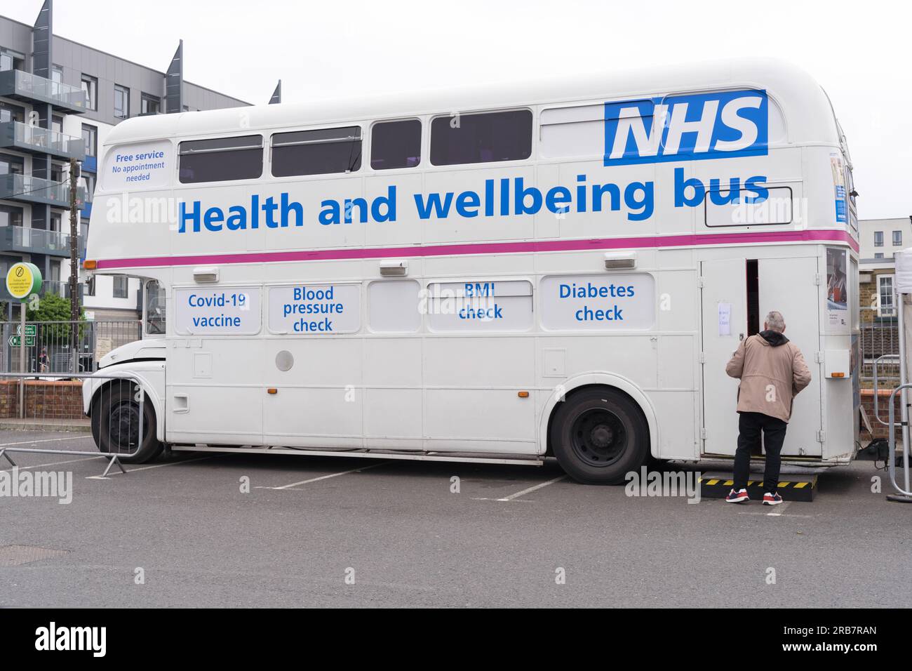 A man walks into NHS bus offering Health and Wellbeing services, Kent England UK Stock Photo