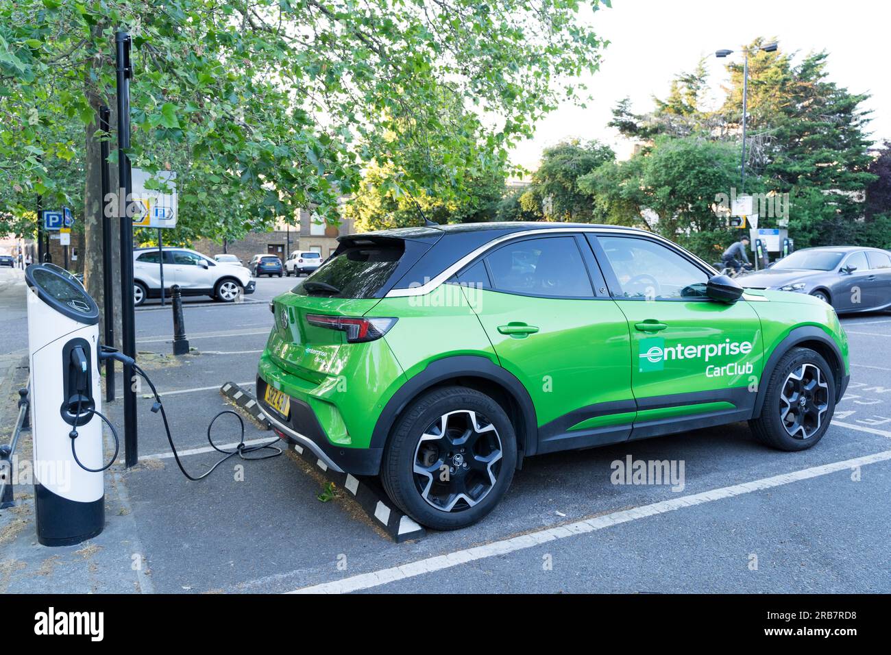 Enterprise car in green is connected to electric charging