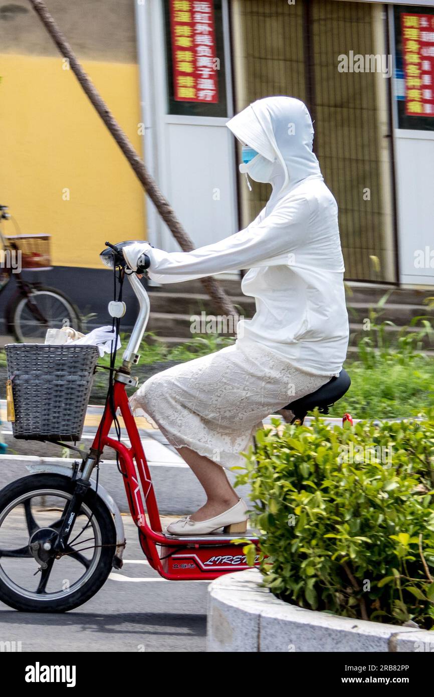 Anyang china july 8 2023 a pedestrian wearing protective clothing