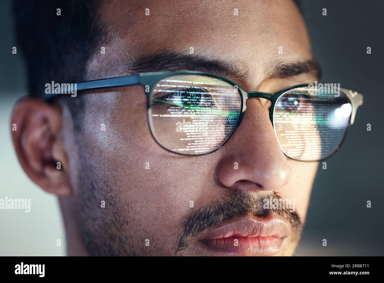 Glasses, man and reflection of programmer on computer working on software, code and data. IT, engineer and serious face of developer with information Stock Photo