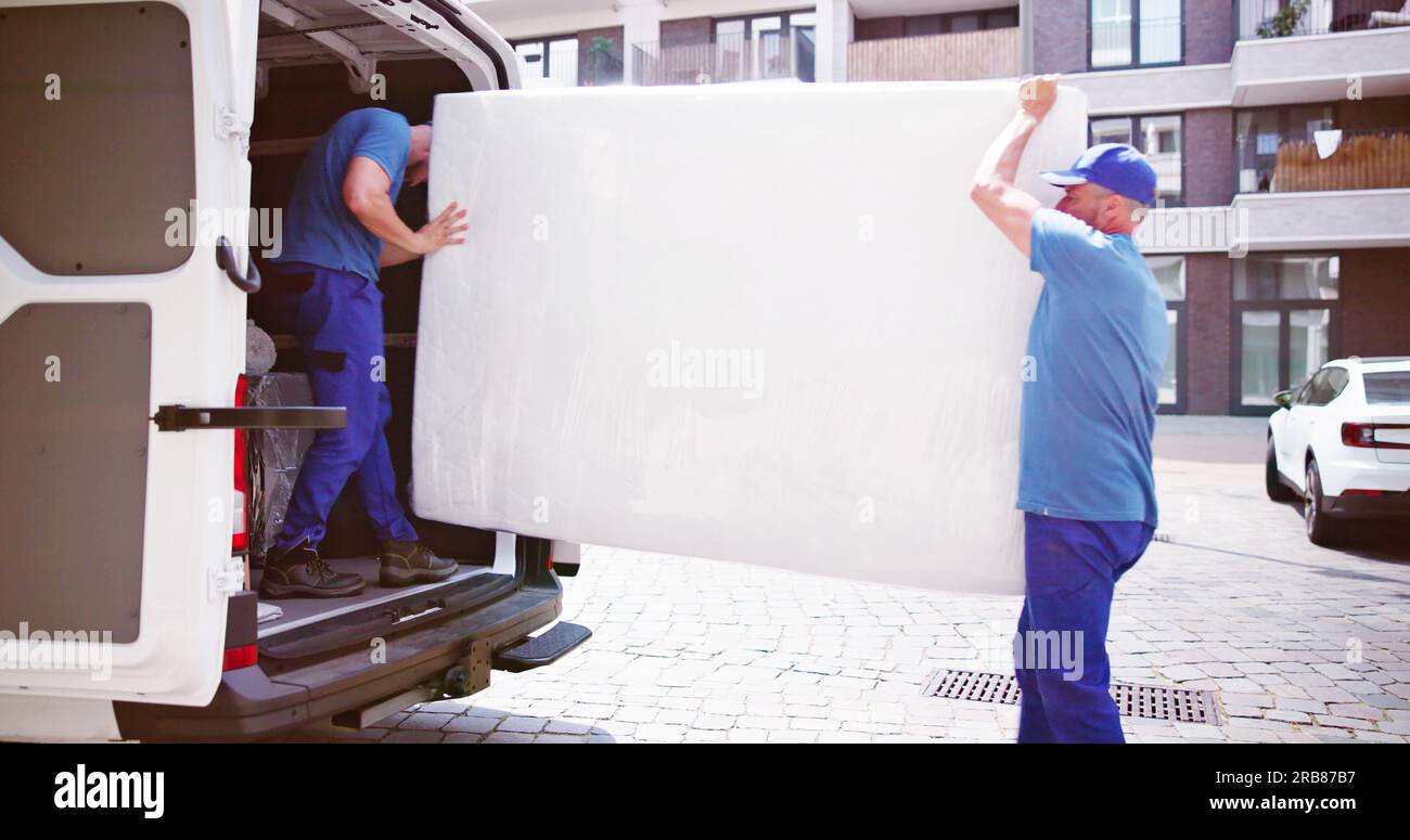 Mattress Delivery Truck. Movers Transporting And Shipping Stock Photo