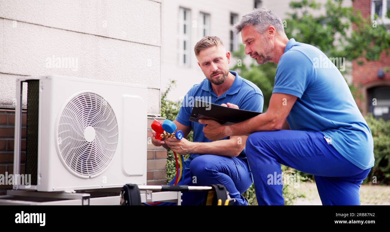 Industrial Air Conditioning Technician. HVAC Cooling System Repair Stock Photo