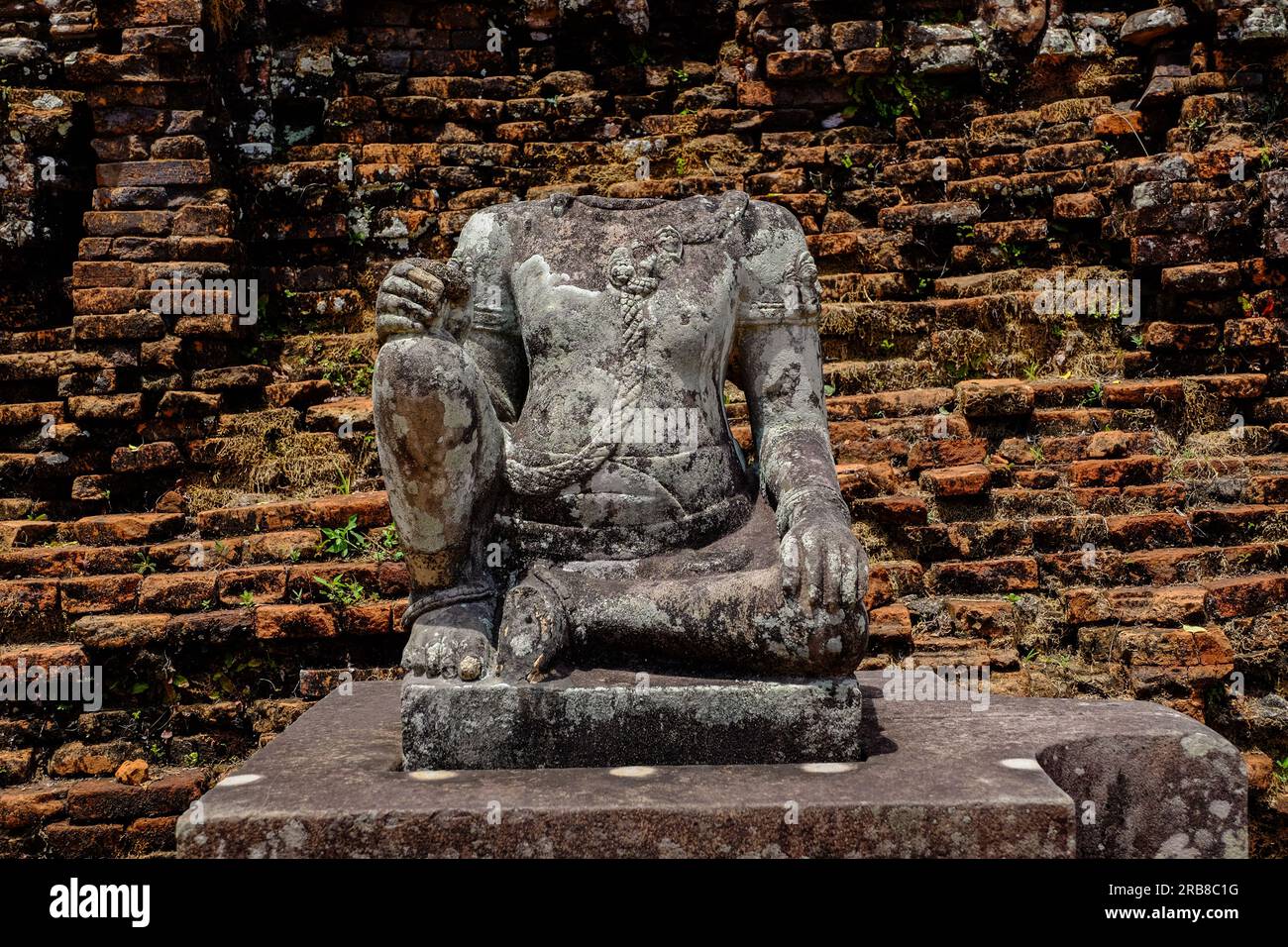 A headless desecrated Buddha statue at the My Son Temple ruins, Vietnam. Stock Photo