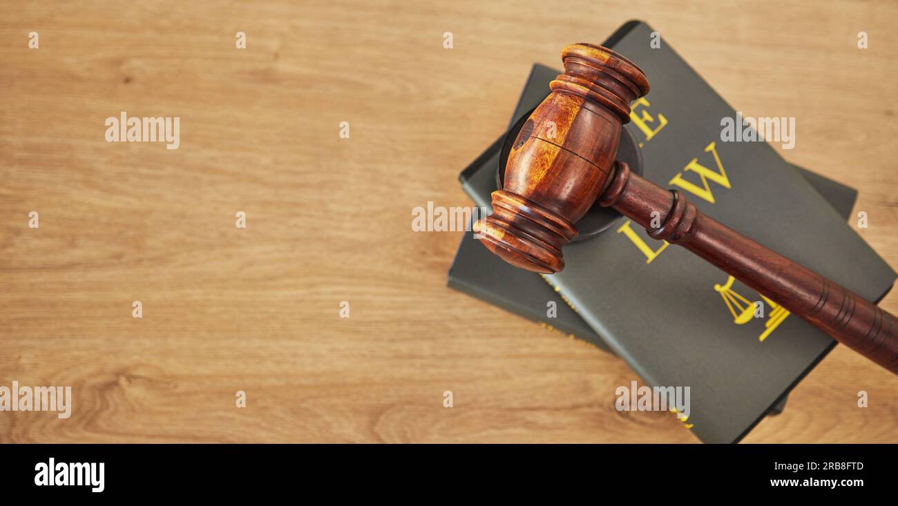 Gavel, law and books on wooden table, space or mockup for judge, justice or lawyer in courtroom. Background, hammer and research knowledge for legal Stock Photo