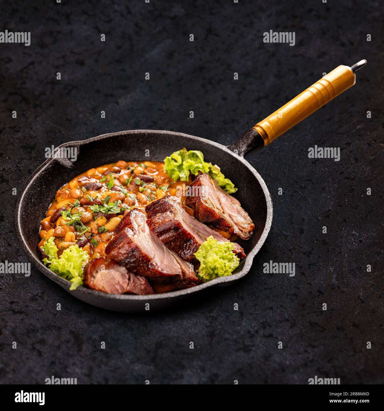 Bean stew with smoked and roasted pork hock slice Stock Photo