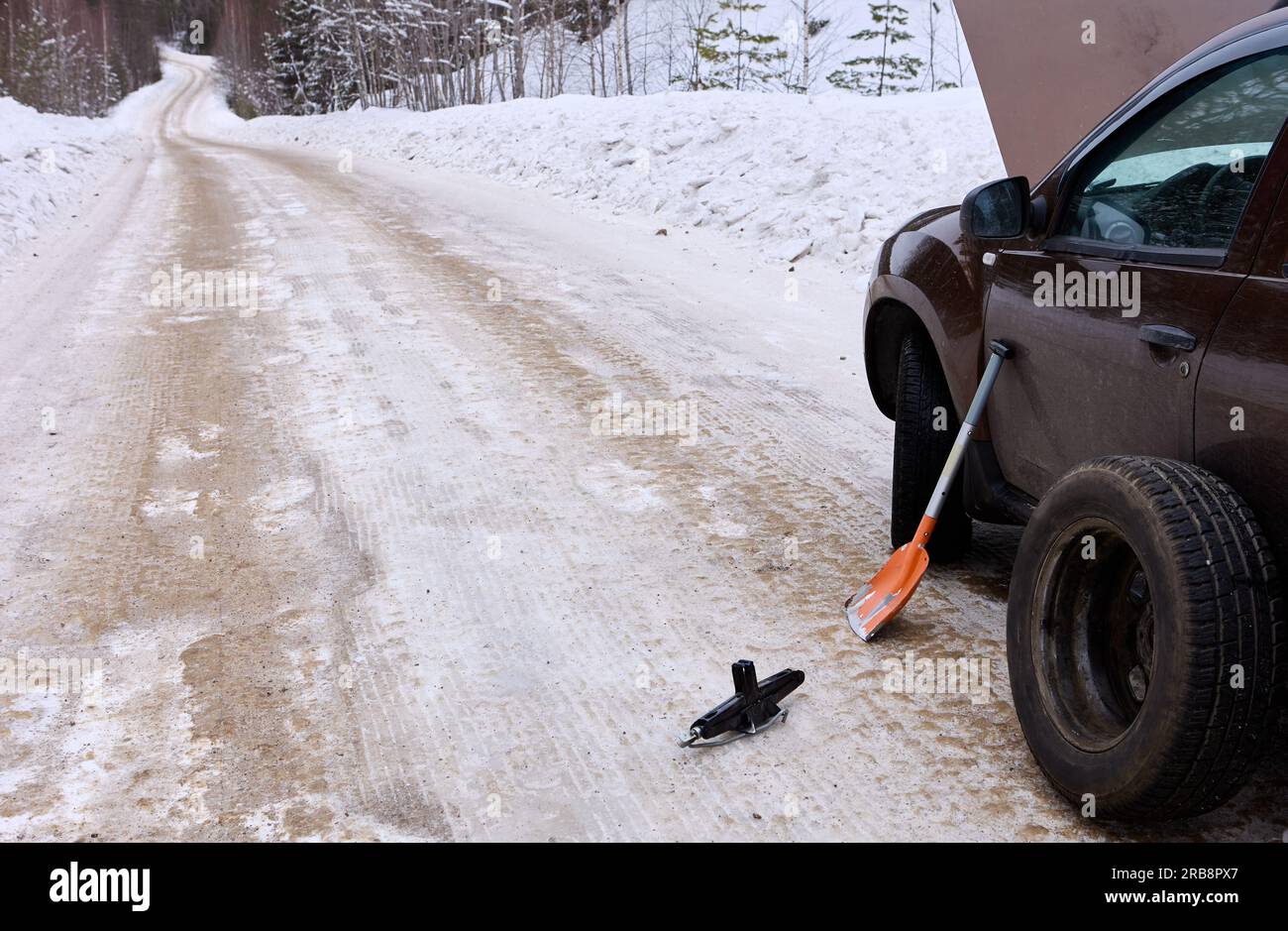 Image showcasing Changing tire on winter rural road, car got into emergency parking on ...