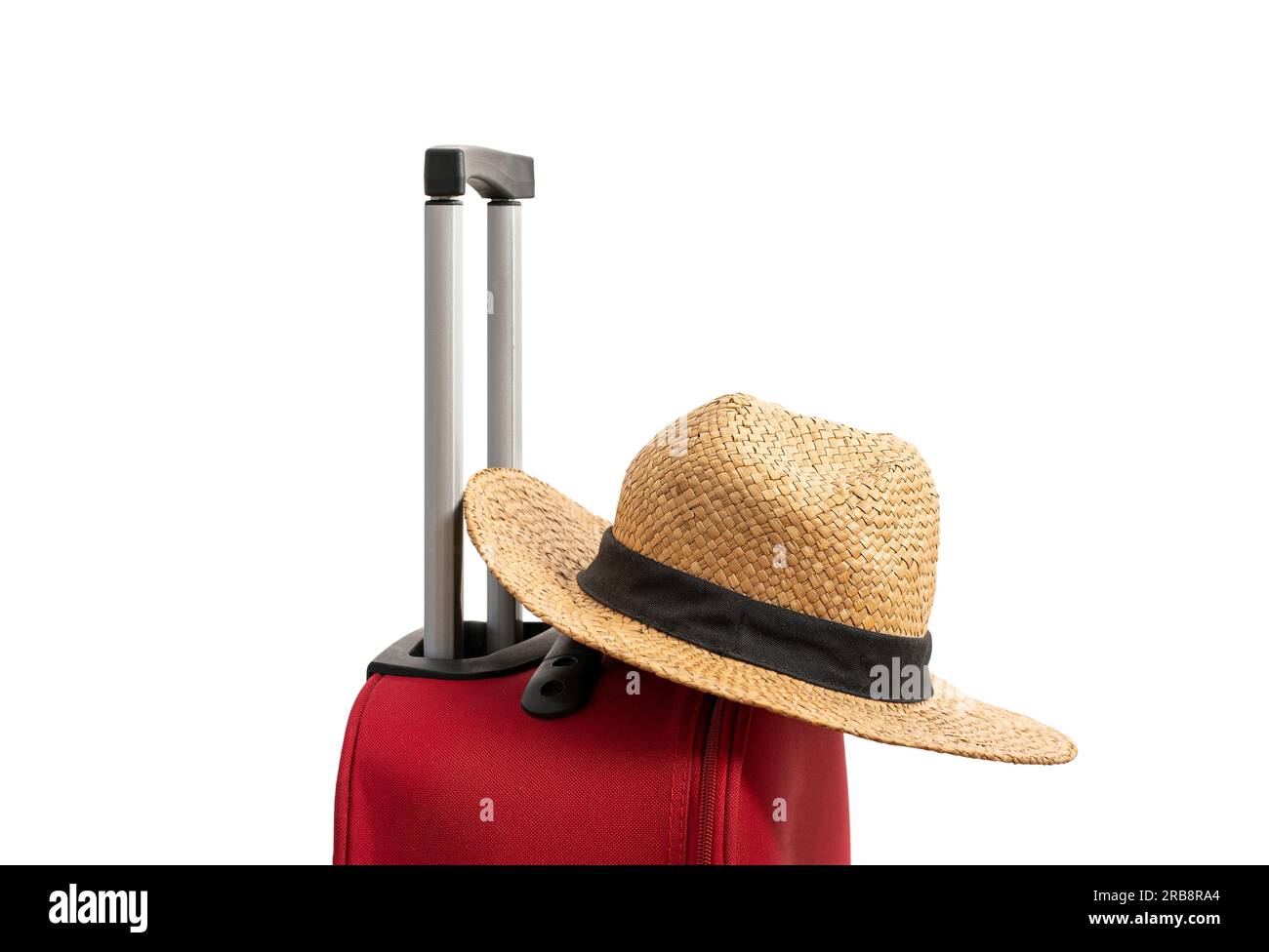 For travel and vacations purposes, a simple modern suitcase in red color is nicely isolated on a pure white background with a straw hat. Stock Photo