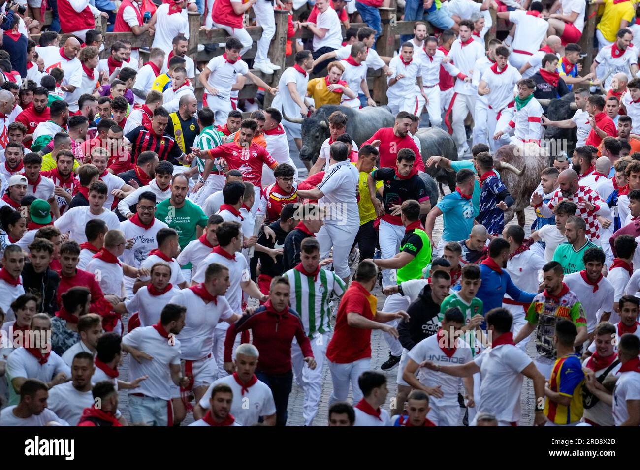 Pamplona, Spain. 08th July, 2023. A crowd of bull runners makes way during the second running of the bulls of the San Fermin festival in Pamplona, Spain, on July 8, 2023. Thousands of people participated in the second of eight bull runs through the narrow streets of Pamplona's city center in the fiesta whose internationally fame is closely associated to Ernest Hemingway who describes it in his book 'The Sun Also Rises'. Photo by Paul Hanna/UPI Credit: UPI/Alamy Live News Stock Photo