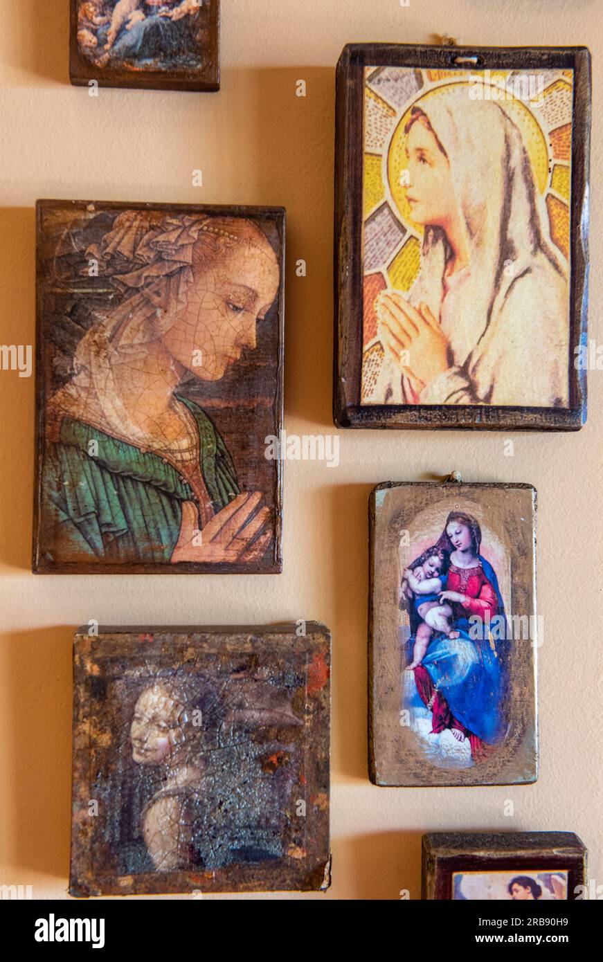religious pictures and icons in frames hanging on the wall , religious