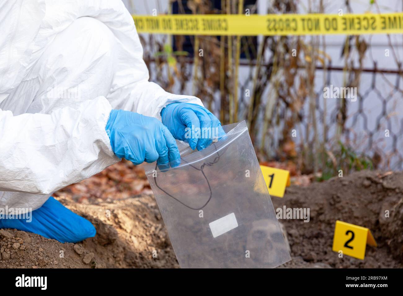 Forensic science specialist at work at a war crime scene investigation Stock Photo