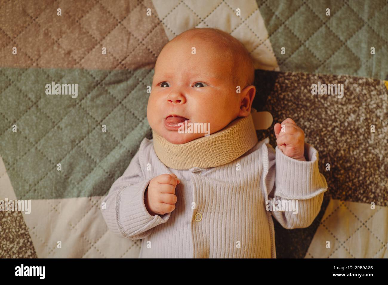 Cute newborn baby in a neck brace. Kid wearing cervical collar