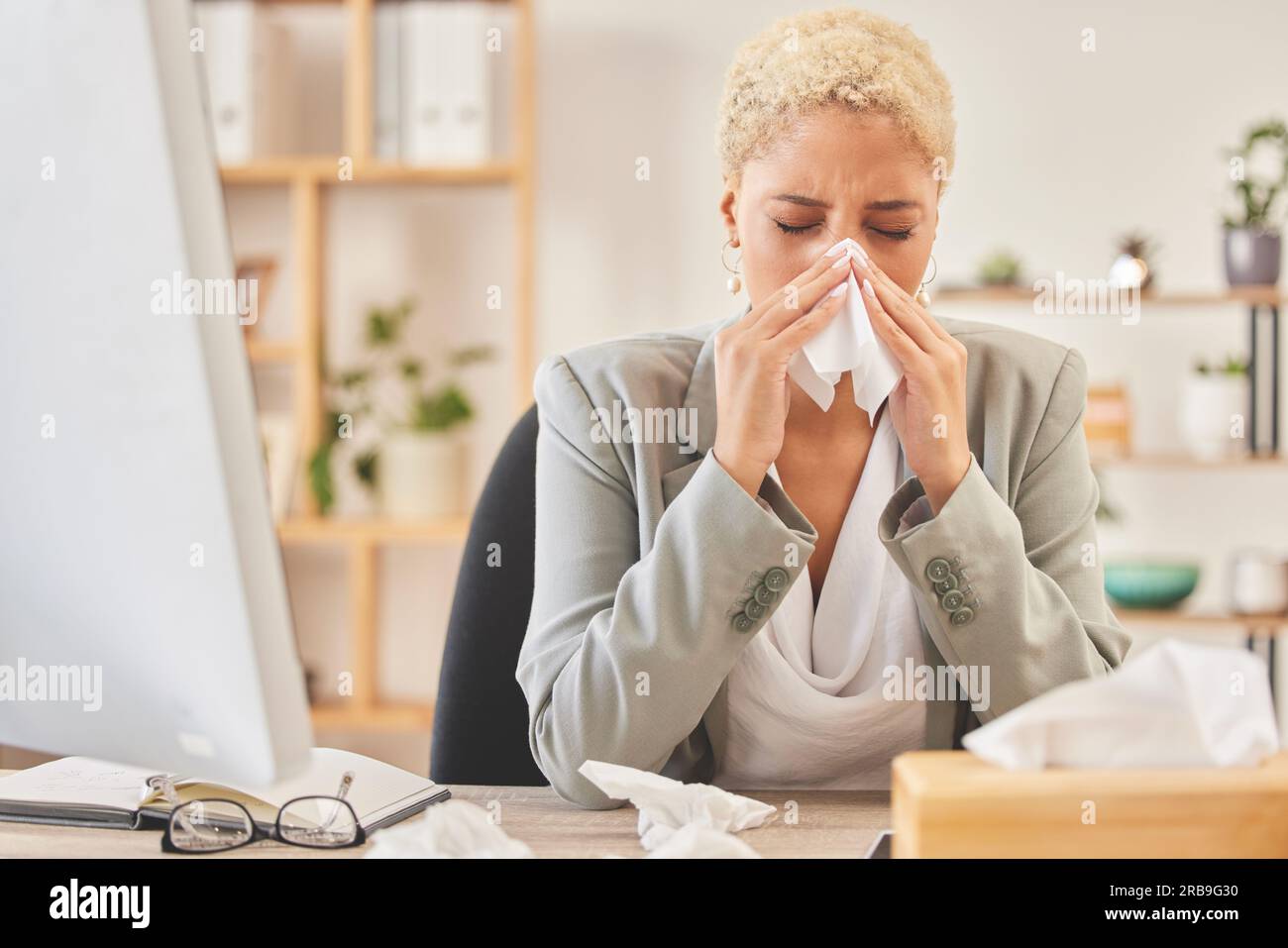 Computer, tissue and a business woman blowing nose while working at a