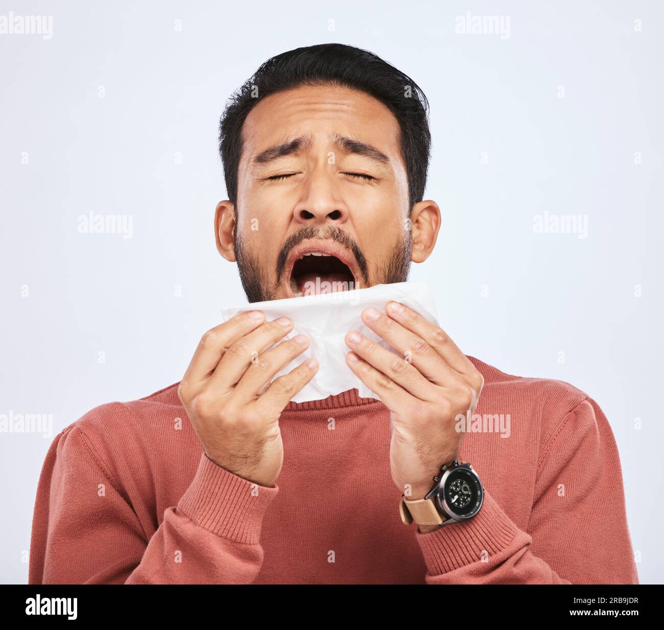 Allergy, sneeze and asian man is sick with tissue in studio with grey