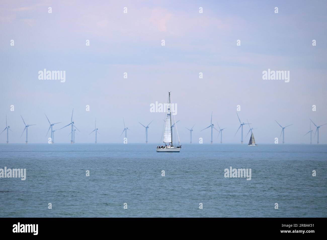 Shoreham, West Sussex, England, UK. 8th July, 2023. Yachts sailing in the English Channel off of Shoreham-by-Sea in West Sussex on a very warm and humid July day. The Rampion wind farm is visible on the horizon. Credit: Julia Gavin/Alamy Live News Stock Photo