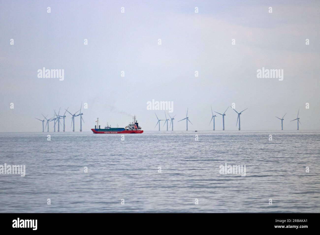 Shoreham, West Sussex, England, UK. 8th July, 2023. Wijnne Barends cargo ship sailing in the English Channel off of Shoreham-by-Sea in West Sussex on a very warm and humid July day. The Rampion wind farm is visible on the horizon. Credit: Julia Gavin/Alamy Live News Stock Photo