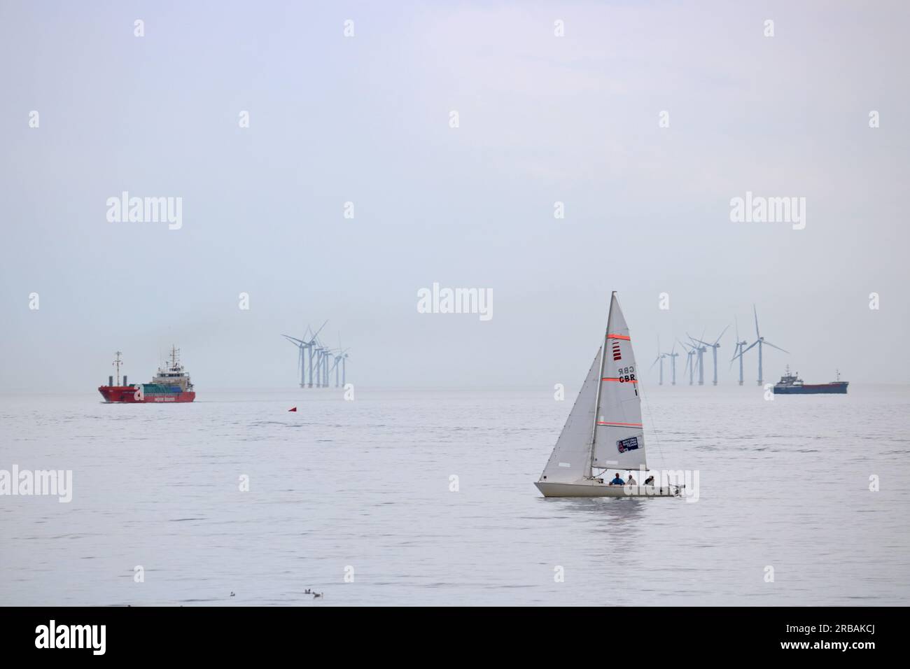 Shoreham, West Sussex, England, UK. 8th July, 2023. Yachts sailing in the English Channel off of Shoreham-by-Sea in West Sussex on a very warm and humid July day. The Rampion wind farm is visible on the horizon. Credit: Julia Gavin/Alamy Live News Stock Photo