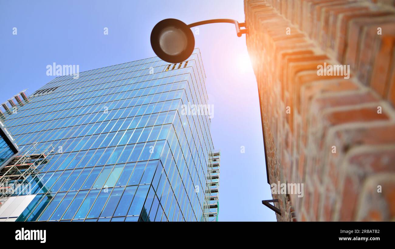 Modern office building against blue sky. Windows of a modern glass