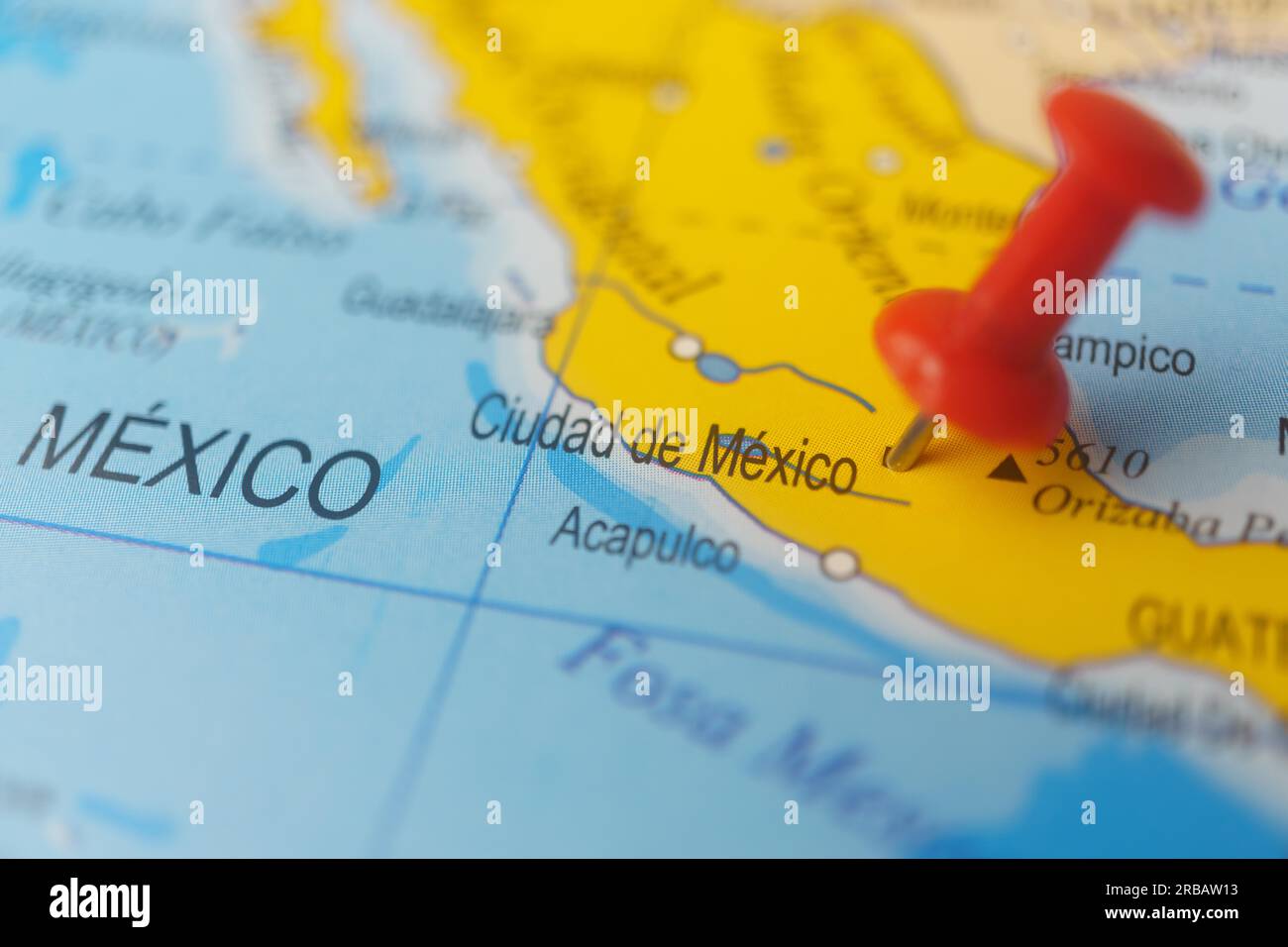 Mexico marked with a red thumbtack on a map with an outoffocus