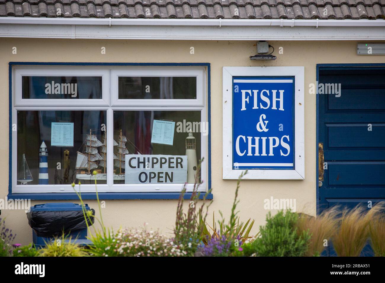Wexford, Ireland - June 24th 2023: Facade of Fish and Chip shop with signs in window Stock Photo