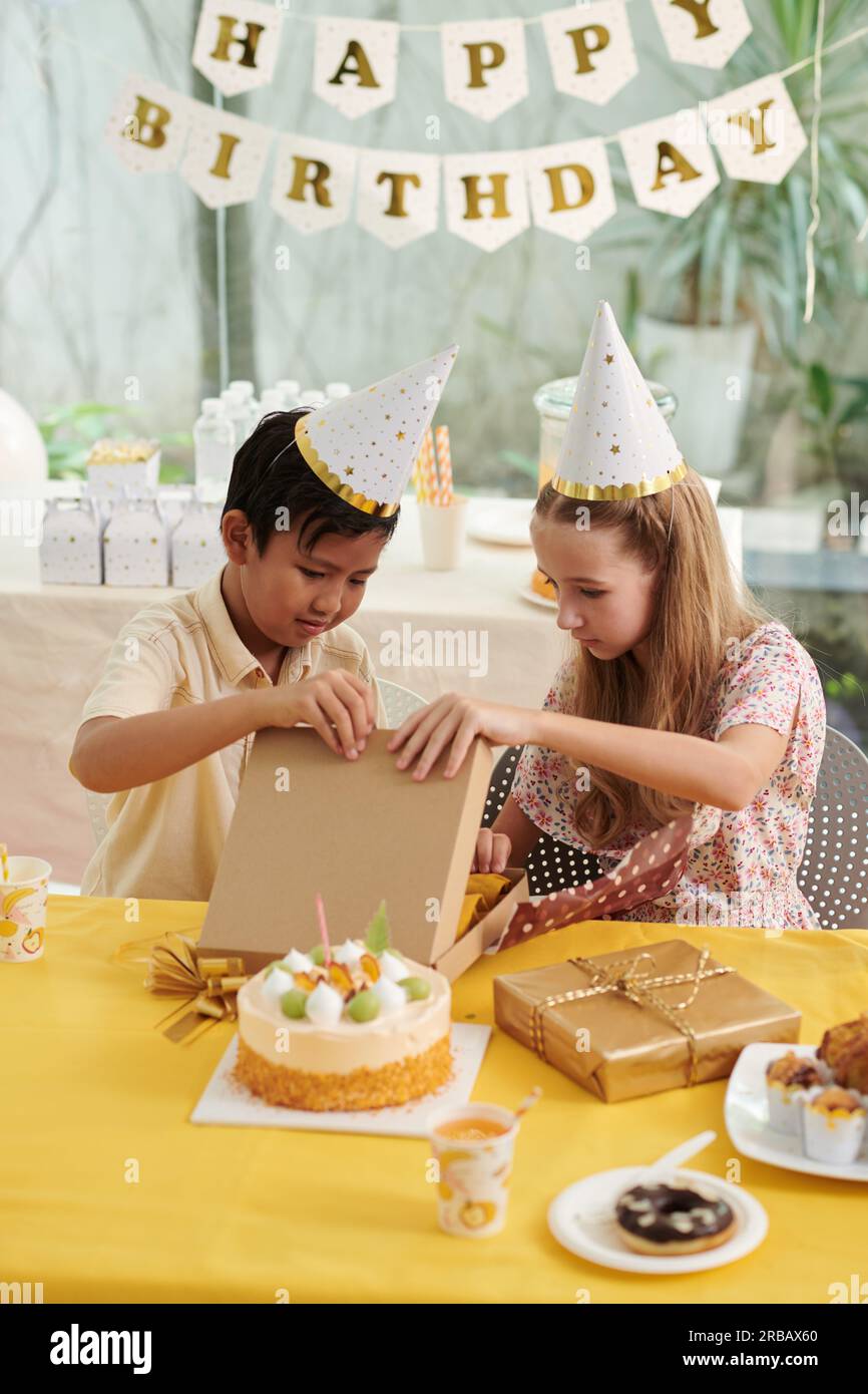 Curious Kids Opening Presents At Birthday Party Stock Photo Alamy curious-kids-opening-presents-at-birthday-party-stock-photo-alamy