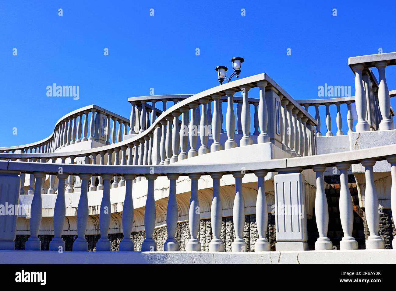 A European-style white balcony connecting the Sky Deck and the Rainbow Deck on the coast of Atami Stock Photo