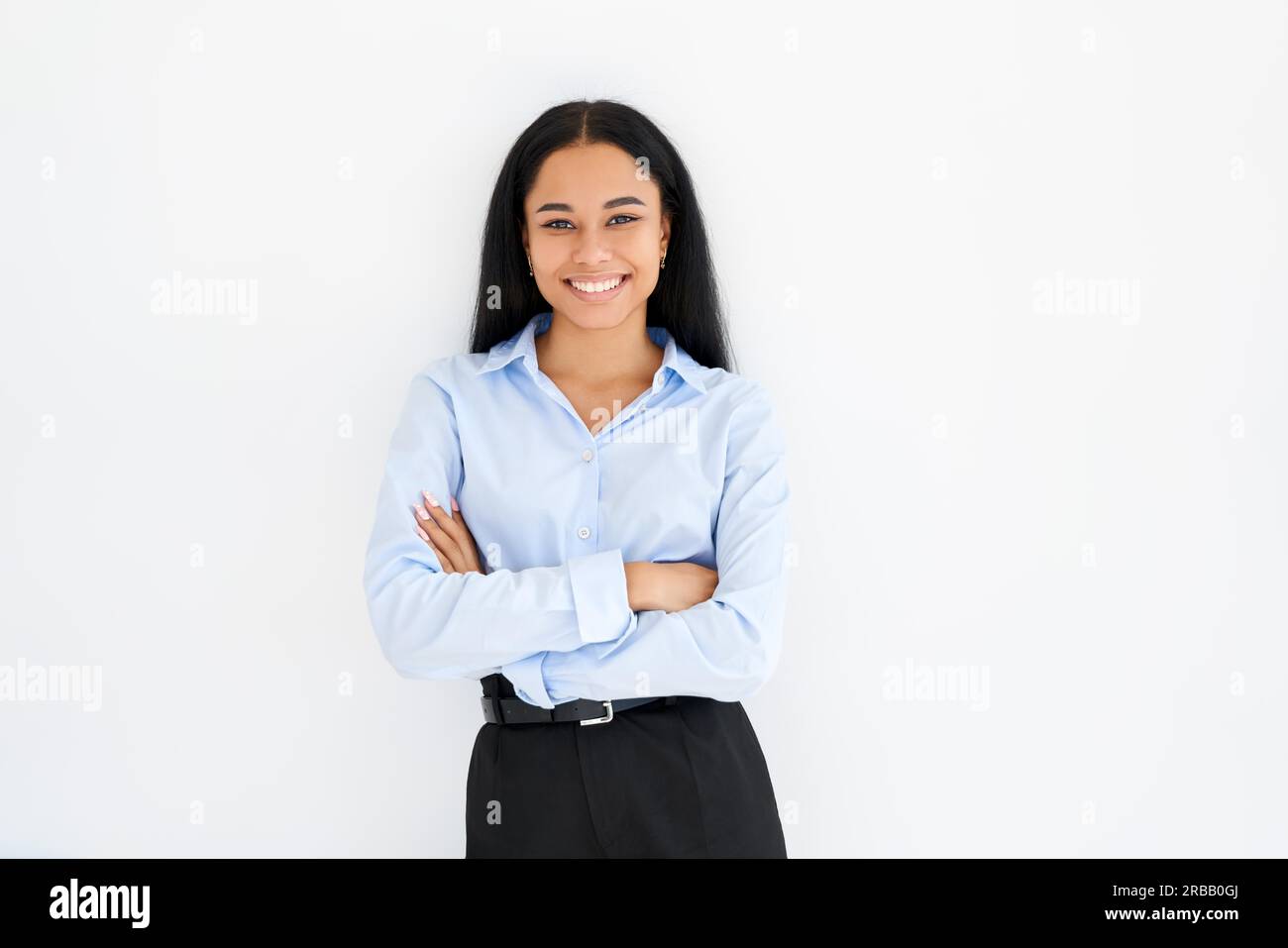 Smiling confident black businesswoman with crossed arms posing on white ...