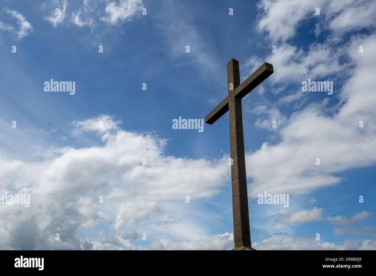 Bray Head cross against a blue sky with white clouds Stock Photo