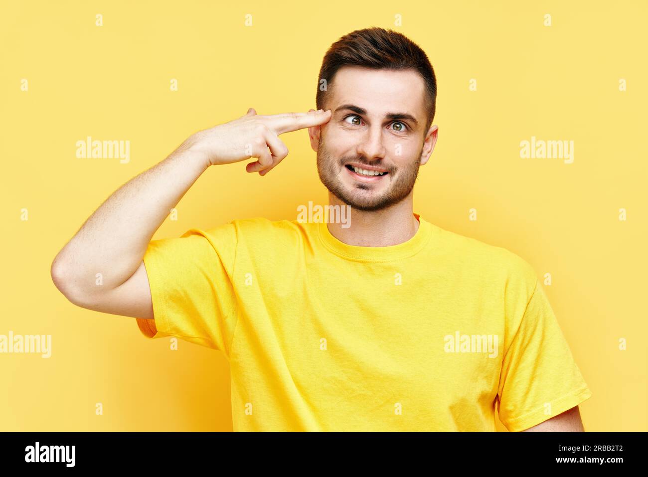 Funny joyful man makes finger gun gesture shooting and killing oneself