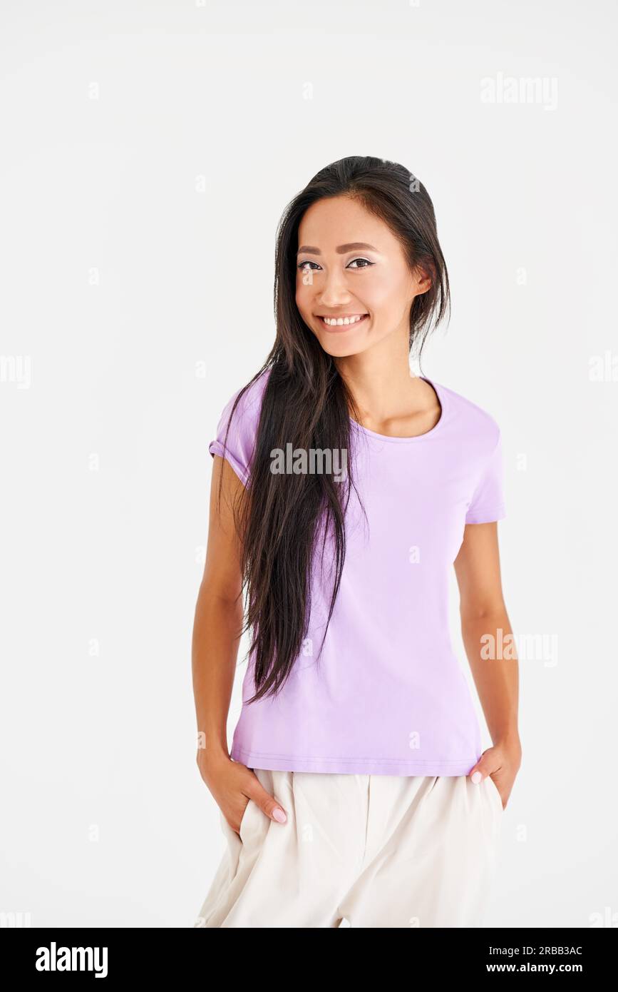 Pretty smiling asian woman in casual clothes posing looking to camera on white background. Female beauty concept Stock Photo