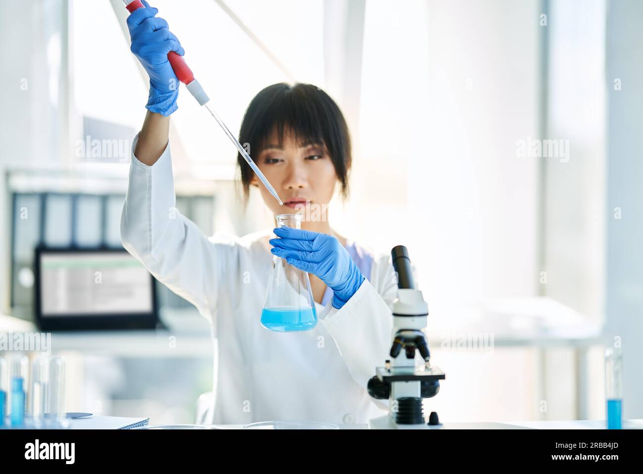 Asian scientist working in big modern laboratory doing some research. Medicine, microbiology, biotechnology concept Stock Photo