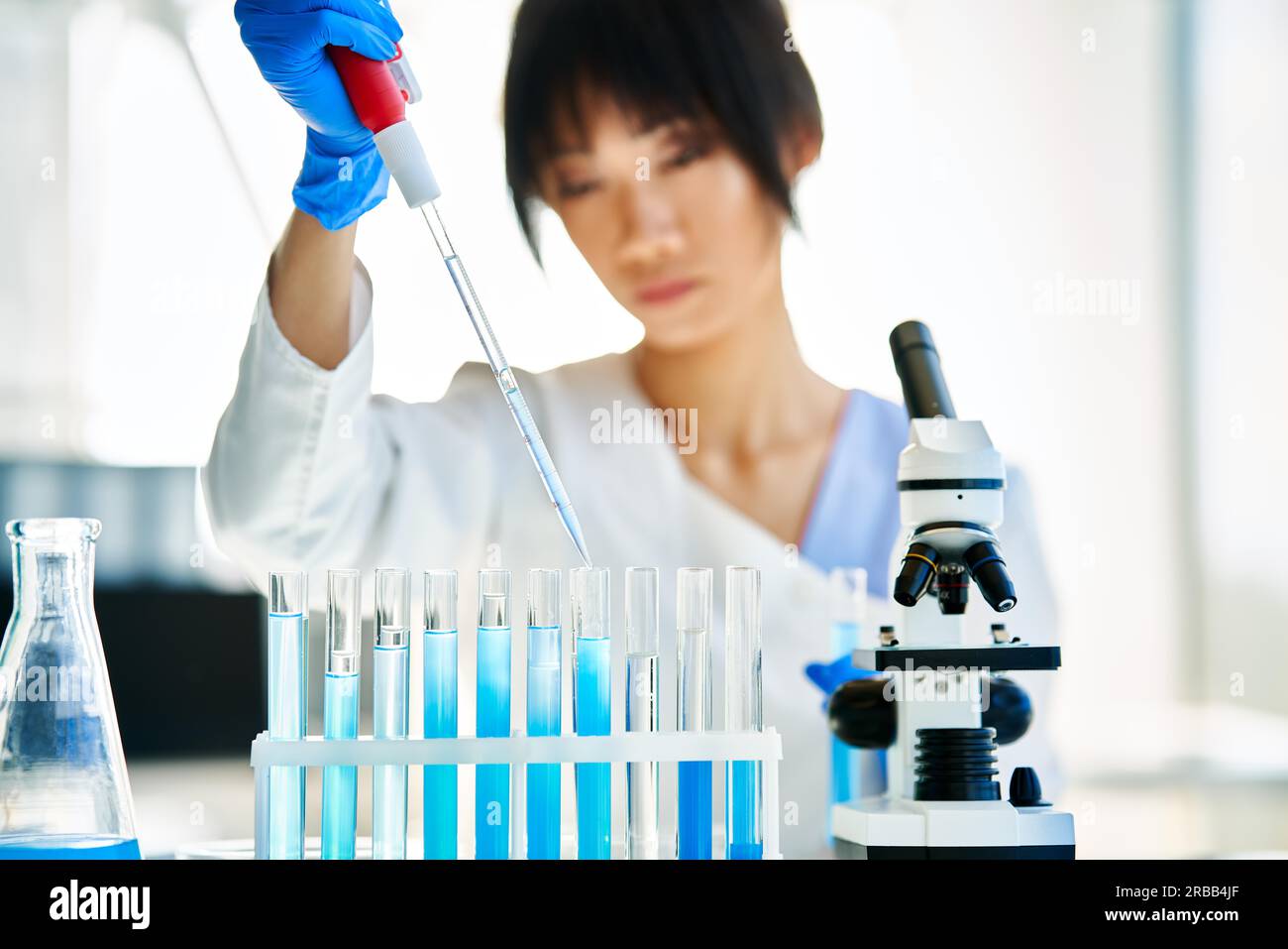 Asian scientist working in big modern laboratory doing some research. Medicine, microbiology, biotechnology concept Stock Photo