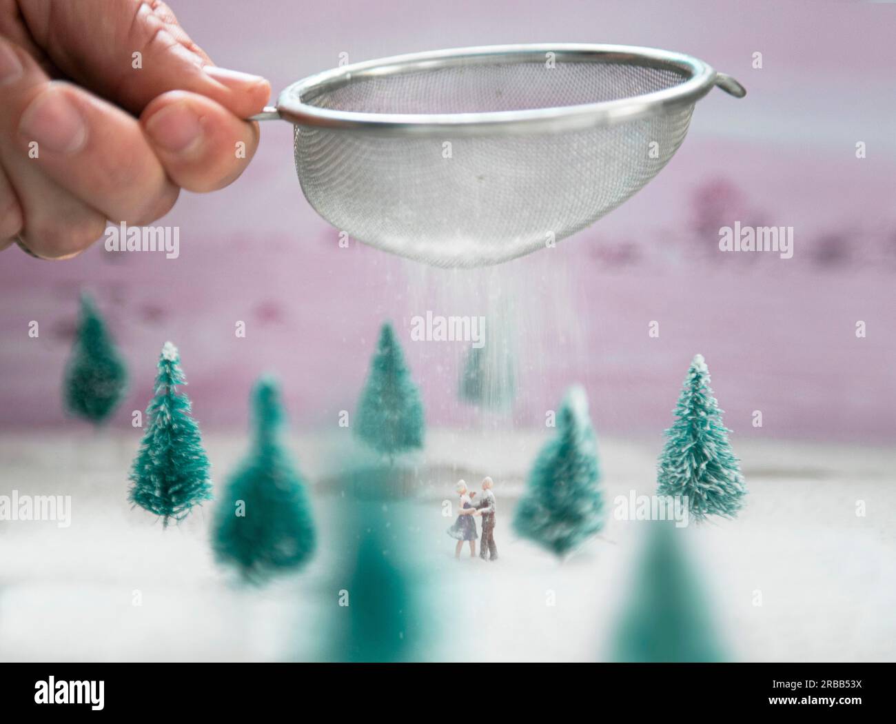 A miniature couple does an ice dance in the icing sugar snow in the forest Stock Photo