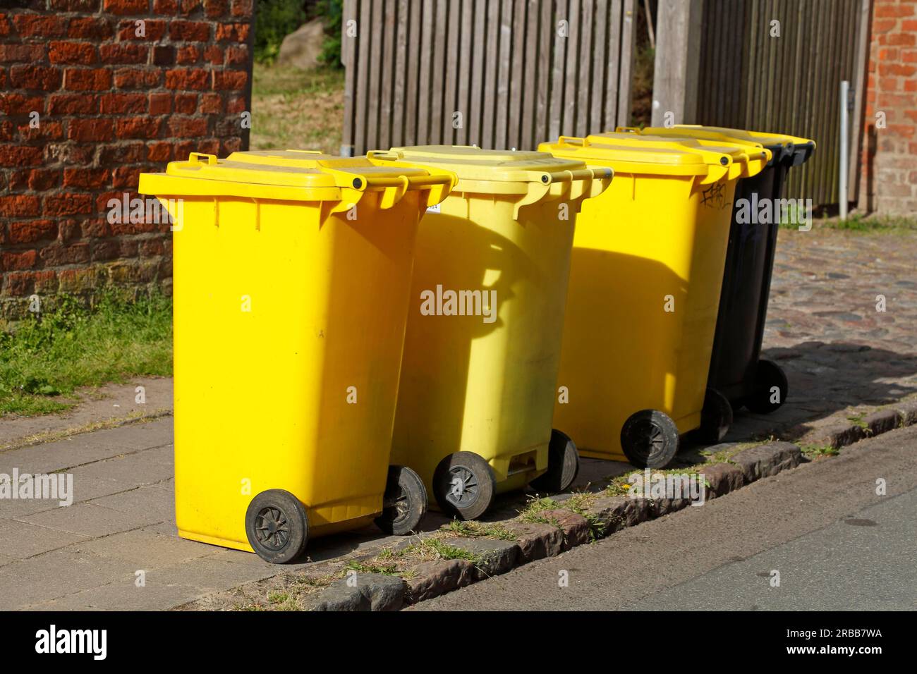 Yellow bins for plastic waste standing on the street, waste separation