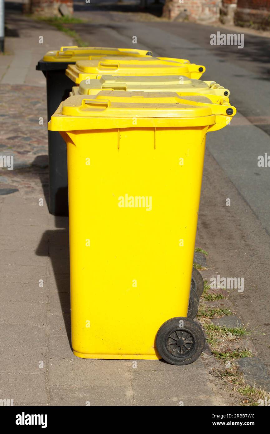 Yellow bins for plastic waste standing on the street, waste separation, waste bins, Germany