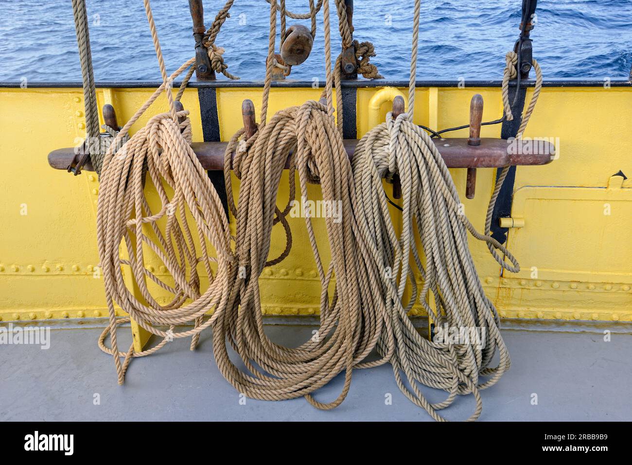 Ropes at the railing, two-master Noorderlicht underway in the Westfjord, Lofoten, Norway Stock Photo