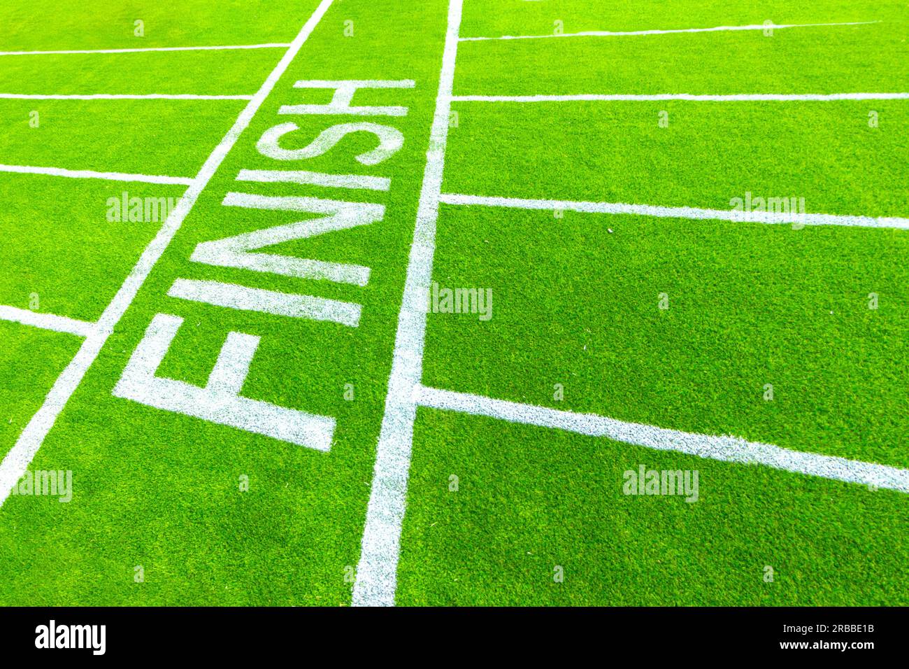 finish line concept white painted lines running race track on grass at