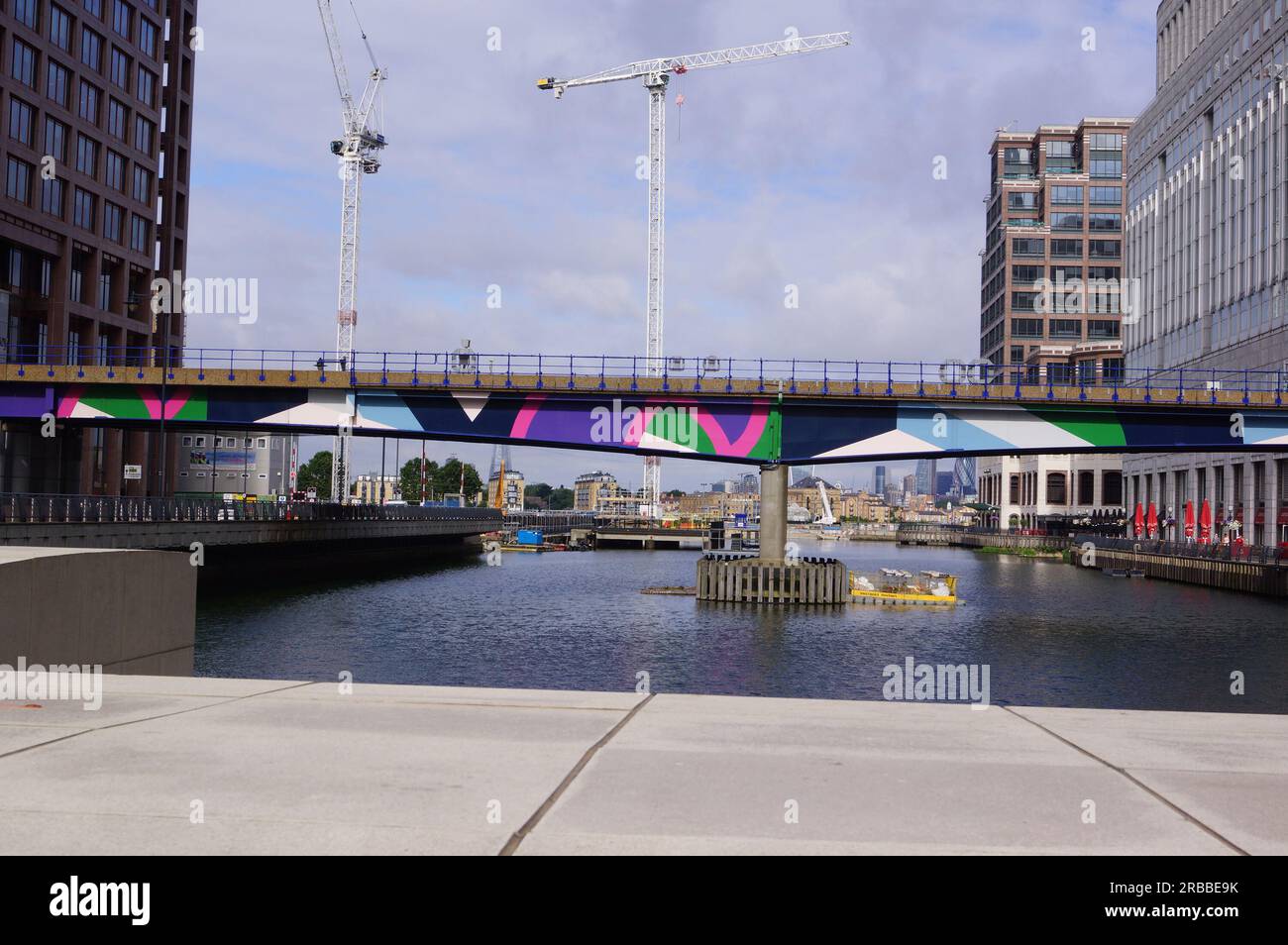 London, UK: bridge of the DLR (Docklands Light Railway) crossing Middle Dock in Canary Wharf, Tower Hamlets Stock Photo