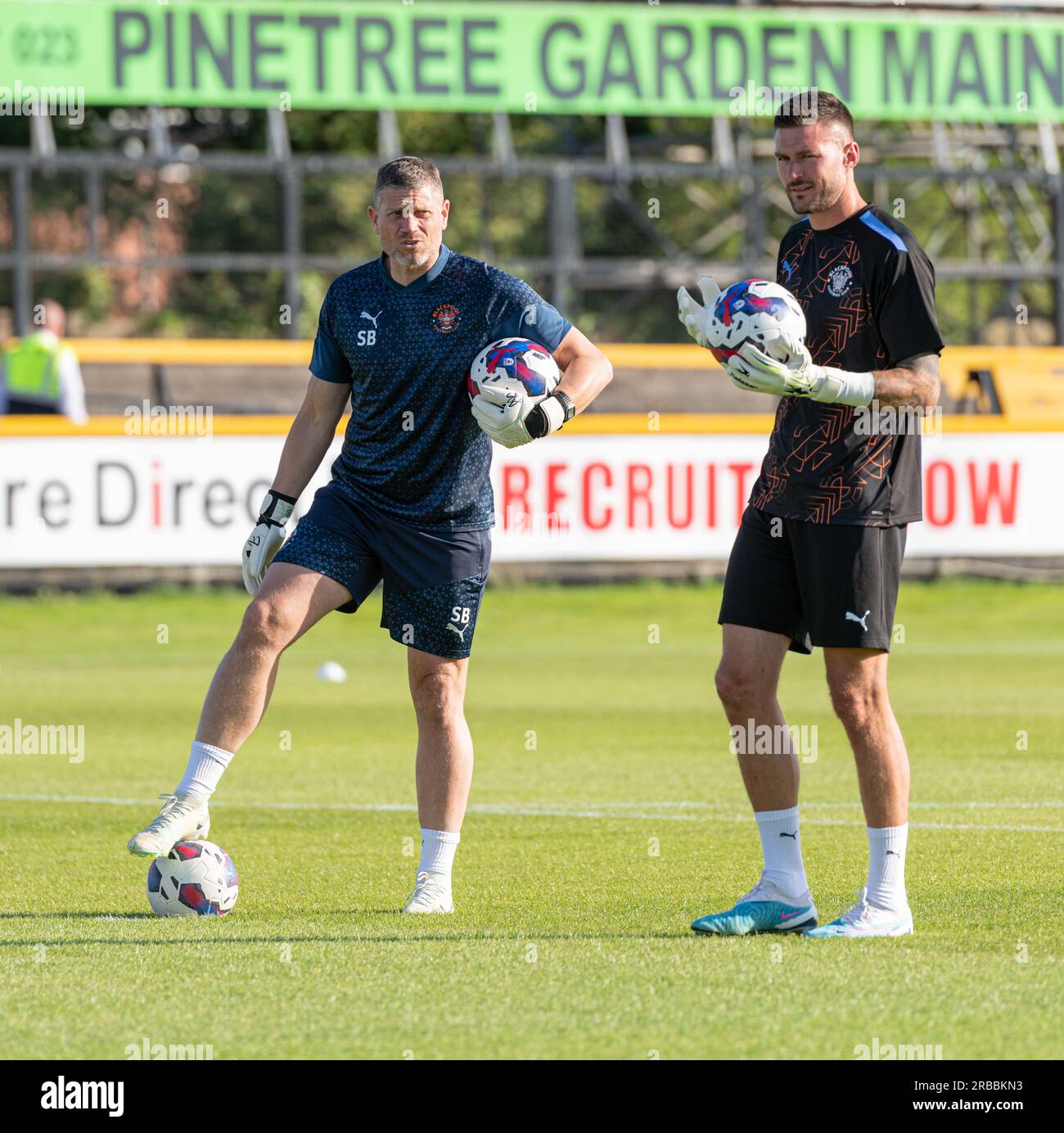 Southport, Merseyside, England, 7th July 2023. Blackpool goalkeeper Richard O'Donnell and goalkeeping coach Steve Banks stand in coverstion during the warm ups ahead of kick off, during Southport Football Club V Blackpool Football Club at Haig Avenue, in a pre season friendly. (Credit Image: ©Cody Froggatt/Alamy Live News) Stock Photo