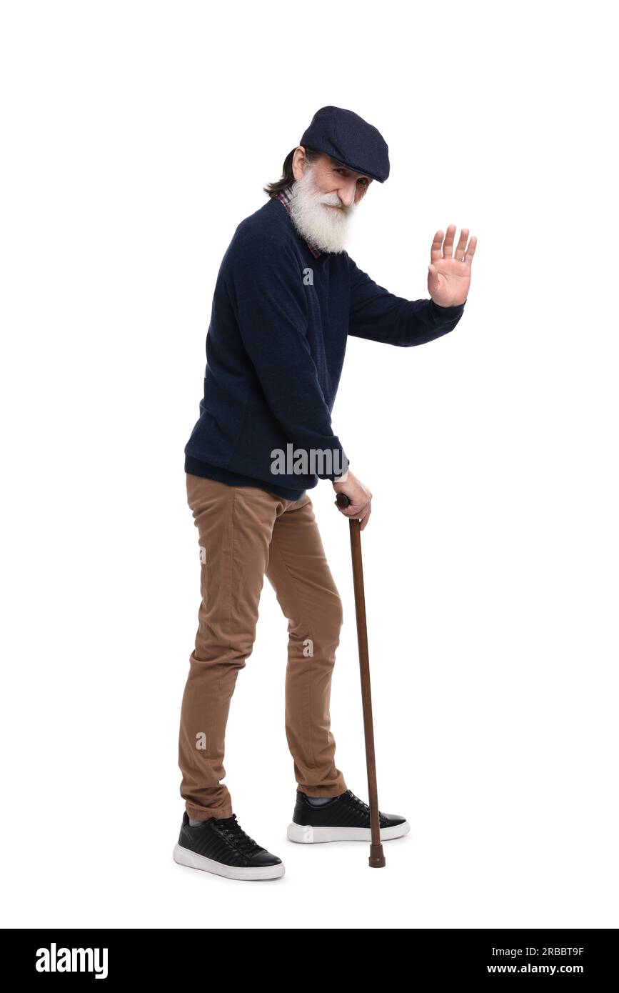 Senior man with walking cane waving on white background Stock Photo - Alamy