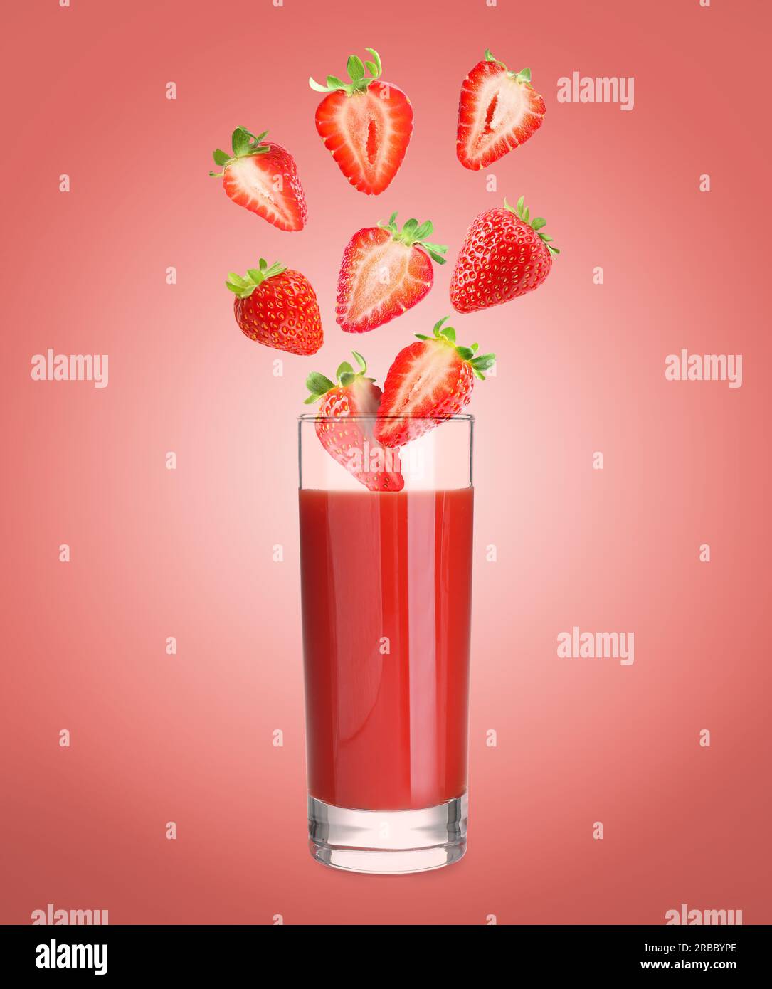 Freshly made strawberry juice on pale red background. Cut and whole