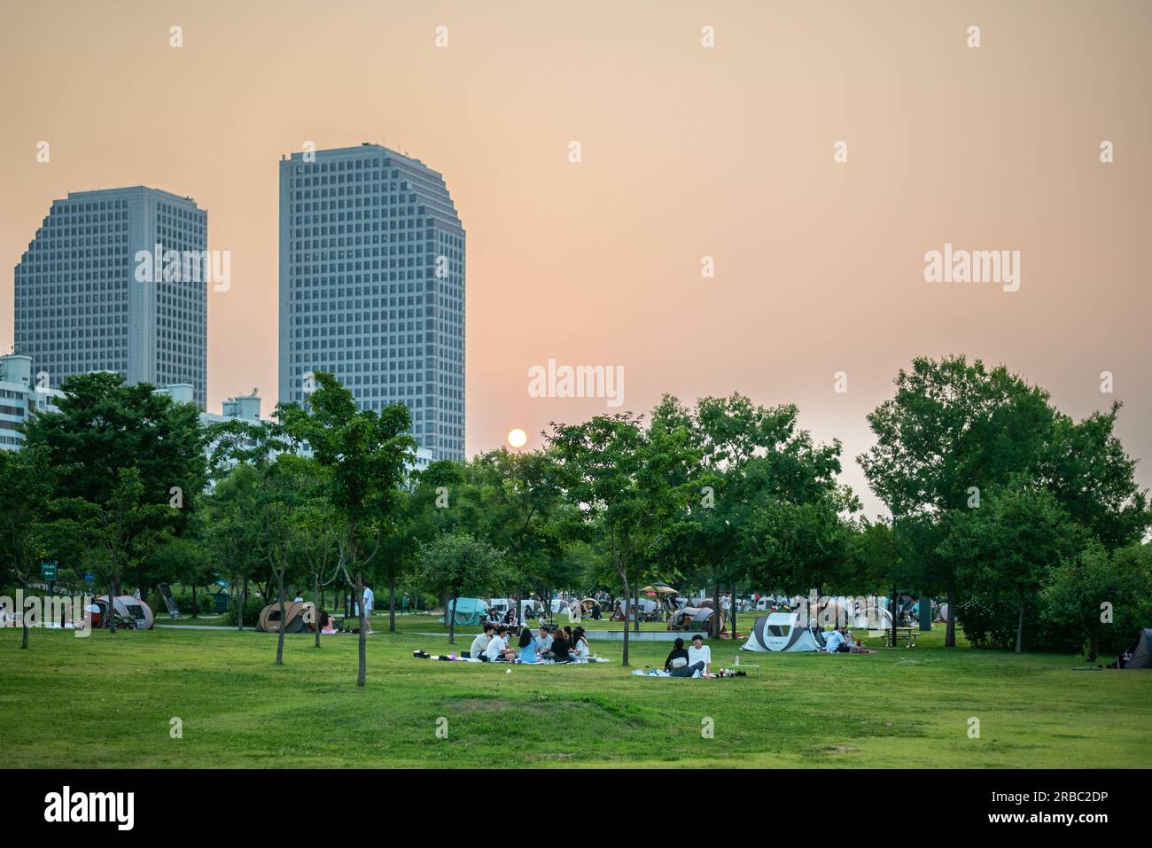 People picnicing in Yeouido park on Han river in Seoul, South Korea on 24 June 2023 Stock Photo